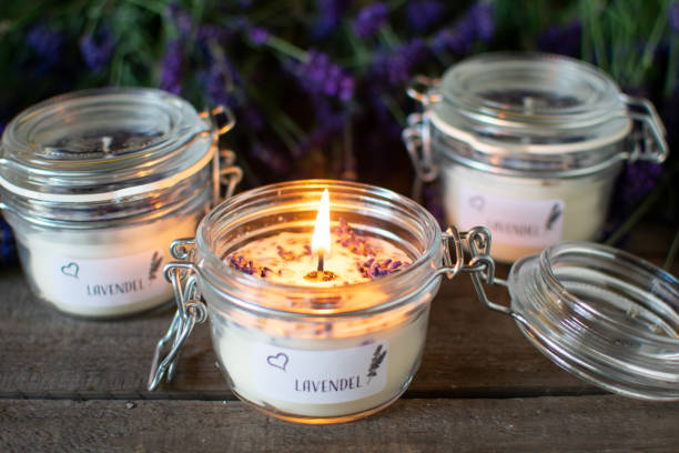 istock burning lavender scented candle with blossoms 1403423465