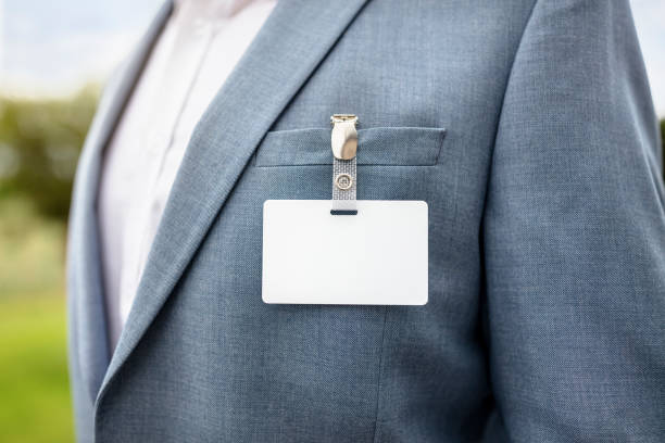 istock Blank security name tag on businessman suit pocket background 1403423686
