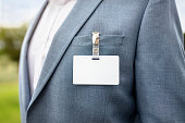 Blank security name tag on businessman suit pocket background