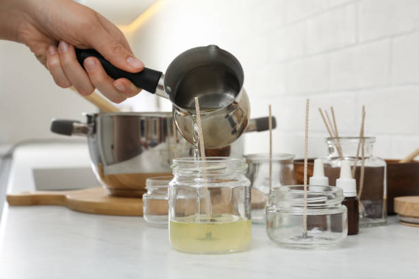 istock Woman making homemade candle at table in kitchen, closeup 1403424909