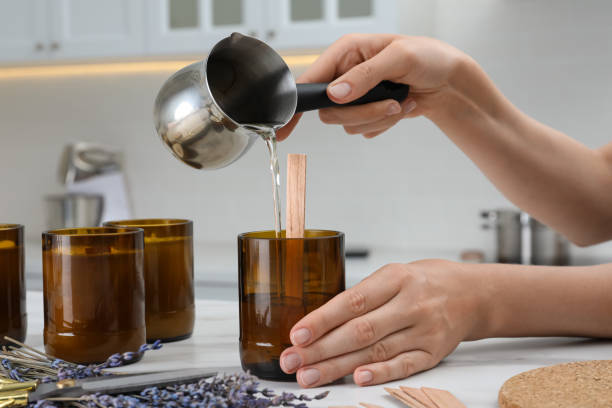 istock Woman making homemade candle at table in kitchen, closeup 1403424932