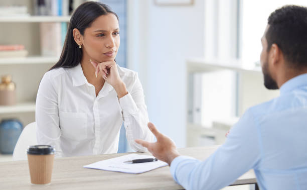 mestiço contratando manjedoura em entrevista com empresário. ceo com currículo e currículo de candidato em busca de vaga, vaga, oportunidade de escritório. candidato sentado e explicando experiência ao chefe de rh - gesturing interview business sitting - fotografias e filmes do acervo