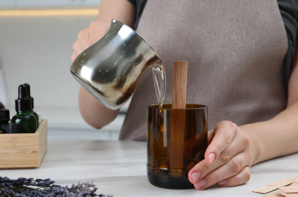 istock Woman making homemade candle at table in kitchen, closeup 1403425332