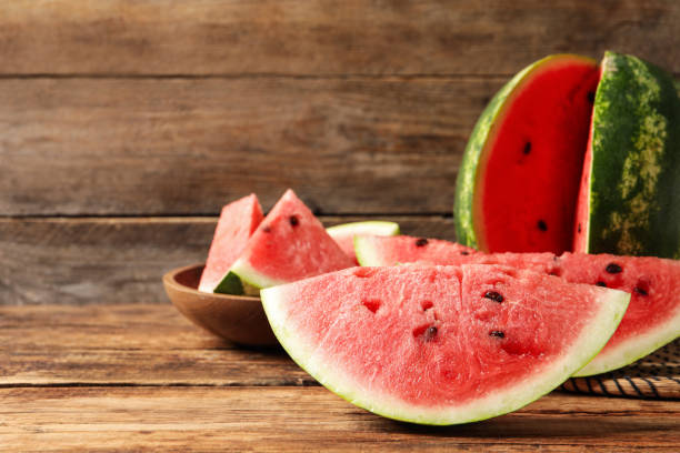 istock Delicious fresh watermelon slices on wooden table. Space for text 1403426640