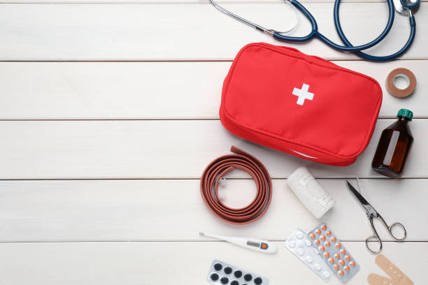 istock Flat lay composition with first aid kit on white wooden table, space for text 1403426932