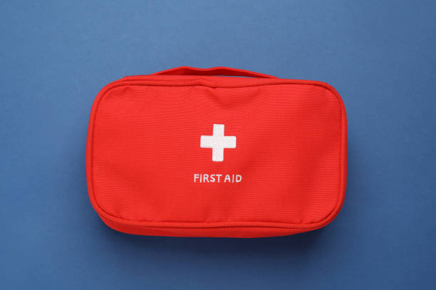 istock First aid kit bag on blue background, top view 1403426936