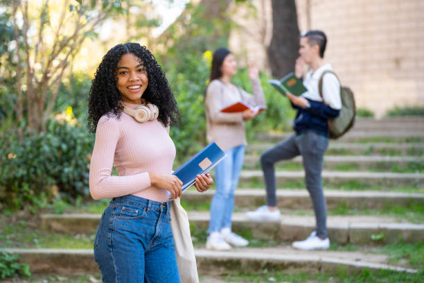 istock Young curly hair black student smiling and looking to the camera 1403429338