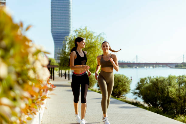 istock Young woman taking running exercise by the river promenade 1403430063