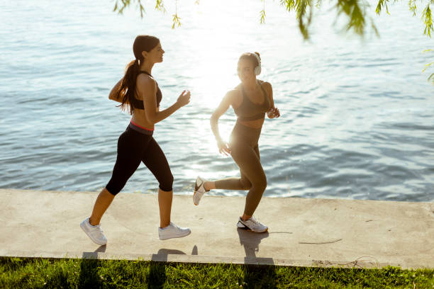 istock Young woman taking running exercise by the river promenade 1403430067