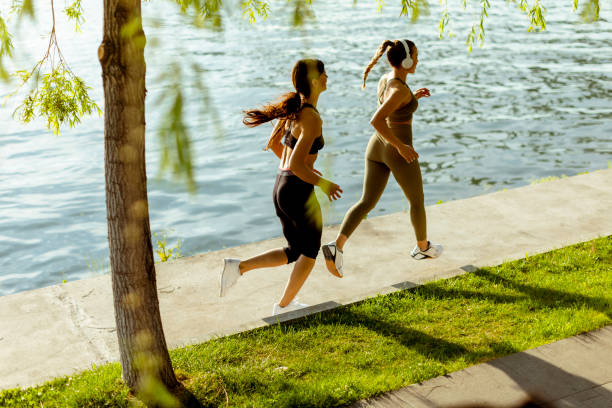 istock Young woman taking running exercise by the river promenade 1403430104