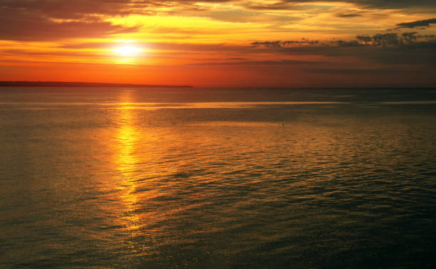 istock Dramatic sunset sky with clouds. Breathtaking sunset over the sea 1403431375