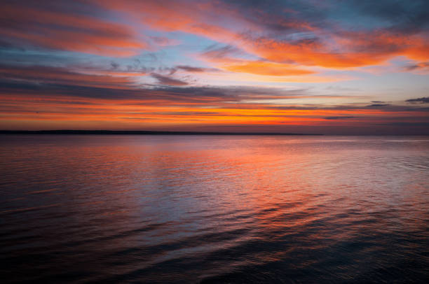 istock Dramatic sunset sky with clouds. Breathtaking sunset over the sea 1403432357