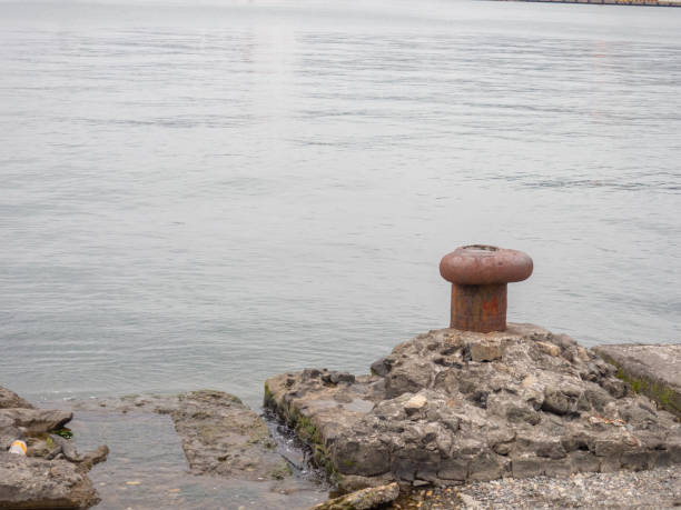 istock bollard on the seashore. Empty pier. Loneliness. 1403434798