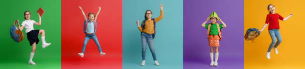 istock Kids with backpacks on colorful background 1403436550