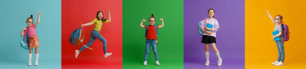 istock Kids with backpacks on colorful background 1403436556