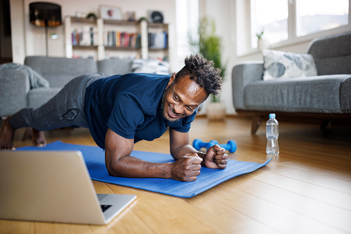 Smiling man working out at home