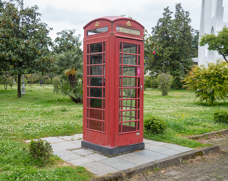 Red telephone box. Fake phone. Scenery in the city park. entertainment world. Street\