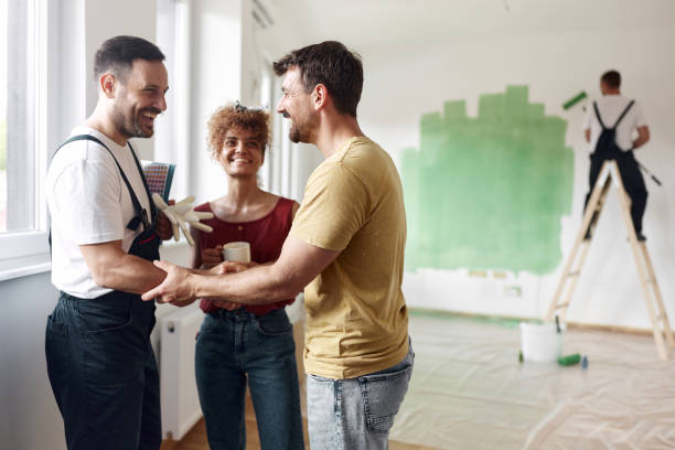We have a deal! Happy couple came to an agreement with house painter at renovating apartment. Copy space. house painter stock pictures, royalty-free photos & images