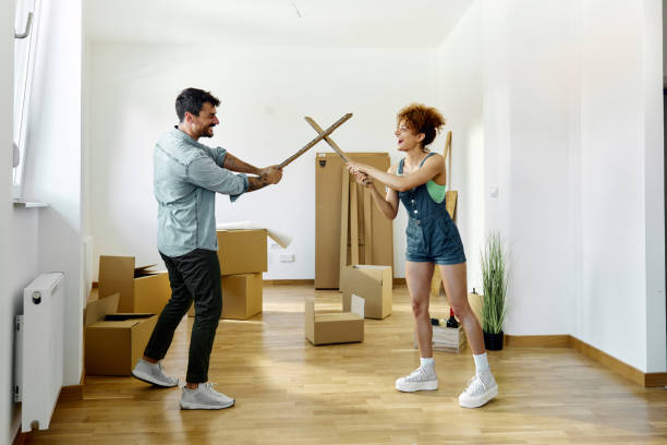 istock Cheerful couple fencing while moving into a new apartment. 1403439455