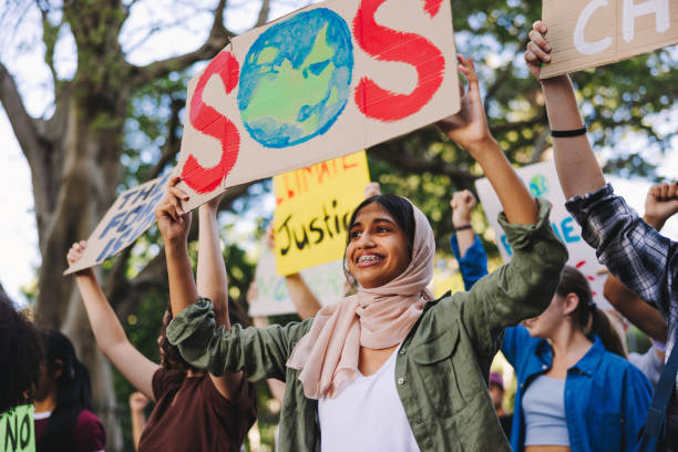 istock Diverse young people standing up for the earth 1403441322