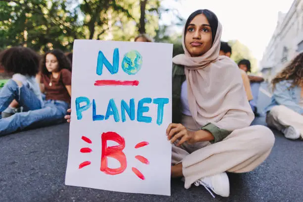 Photo of Muslim girl protesting against climate change and global warming