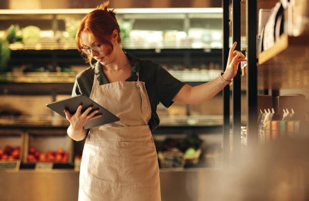 istock Supermarket owner using a digital tablet in her shop 1403441642