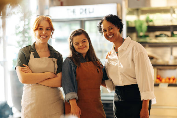 istock Happy retail workers smiling at the camera in a grocery store 1403441704