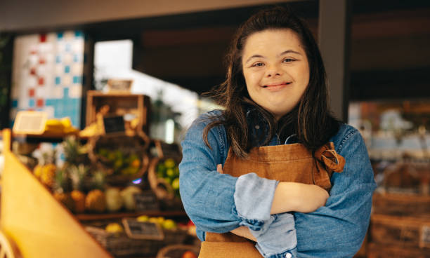 istock Shop employee with Down syndrome smiling at the camera 1403442464