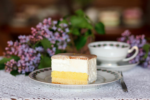 A piece of cake and a cup of coffee on the table.