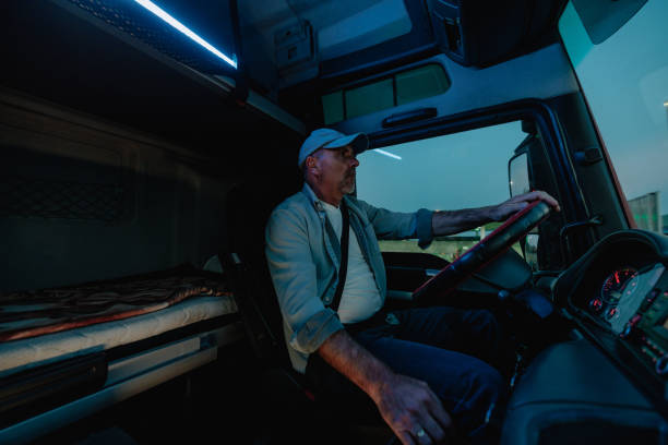 istock Man with the cap is driving the truck 1403448429