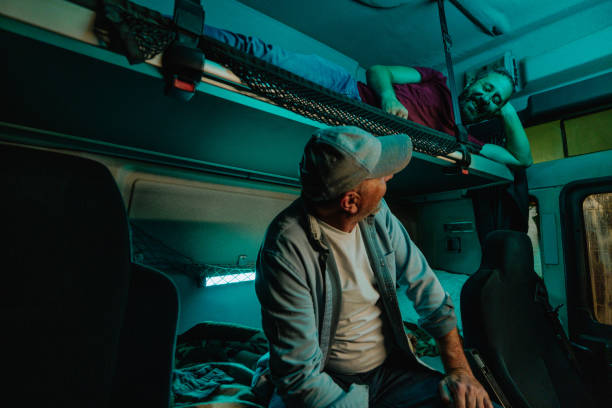istock Truck drivers in bunk bed talking 1403448486