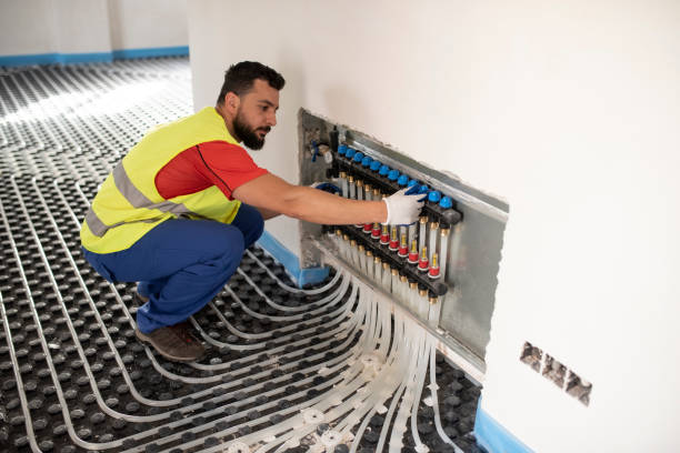 Man installs and checks underfloor heating. Floor heating system installation stock photo