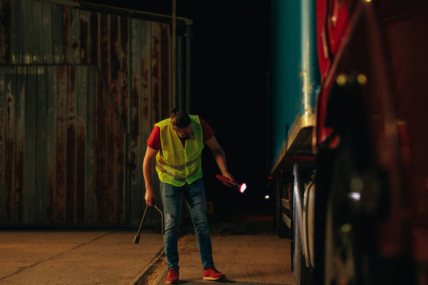 istock Routine truck tires checking by a truck driver 1403449321