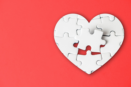 Missing piece in the heart shaped jigsaw puzzle fits into place.