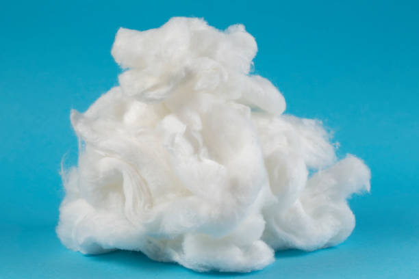 istock White piece of cotton wool on a blue background. Delicate cloud.Piece Cotton wool isolated on blue 1403451236