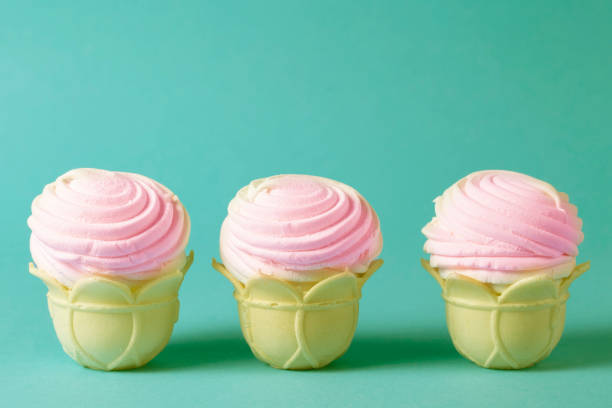 istock Pink cakes in a waffle cup on a vintage emerald background. 1403451321