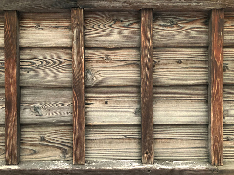 Section of an old dark gray wooden fence.