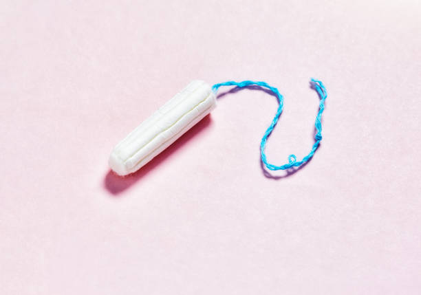 Tampon in close-up on a pink background with copy space stock photo