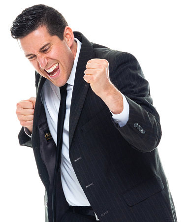 Front view of caucasian male manager standing in front of white background wearing businesswear who is shouting and celebrating