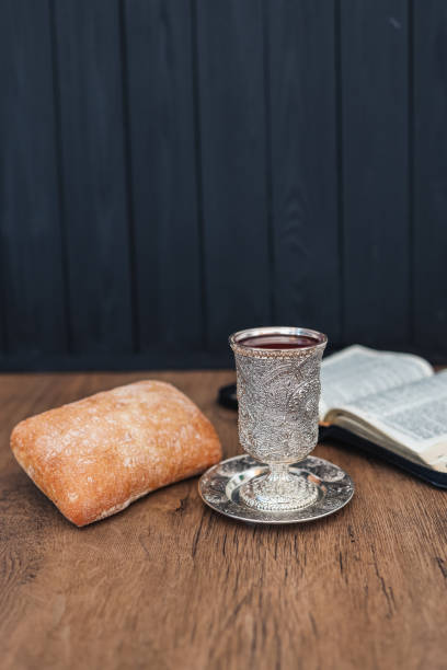 istock Christian communion, bread and wine on wooden background 1403459804
