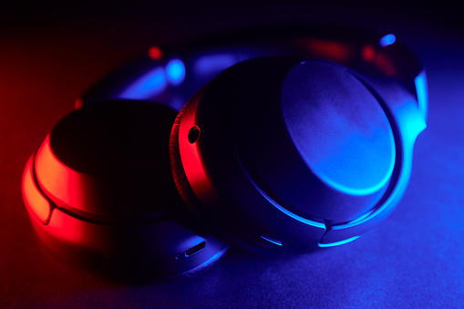 Close up of audio headphones with red and blue gradient led lights