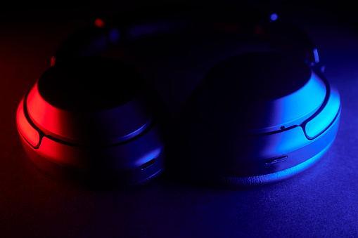 Close up of audio headphones with red and blue gradient led lights