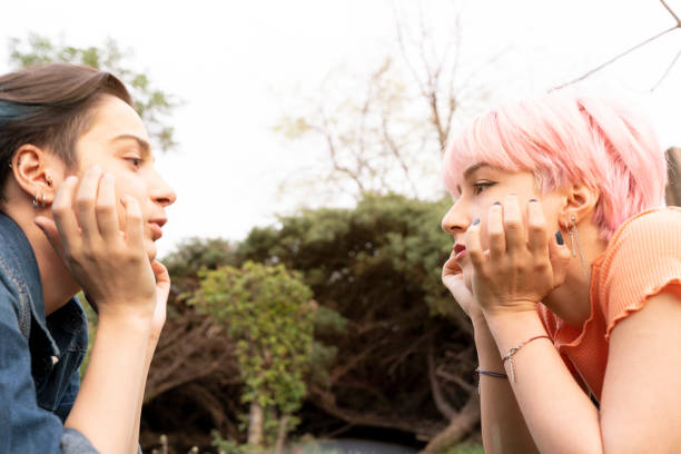 istock Two young lgbt women are lying down on grass in a park 1403460107