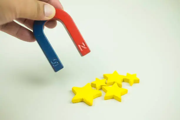 Photo of Using U shape steel magnet to suck the stars to giving five-star symbol for highest satisfaction, quality in services.