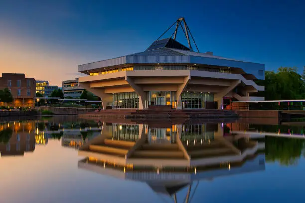 A blue hour shot of the Central Hall and Lake at York University