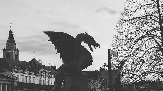 Black and white 16x9 photo of the dragon statue in Ljubljana