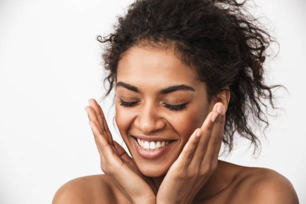 istock Happy young african woman posing isolated over white wall background. 1403463793