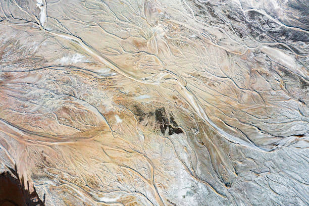 istock Abstract background or texture depicting a wavy pattern of earth and water, water flowing on the ground, a beautiful natural pattern from a great height, an artificial lake 1403464145