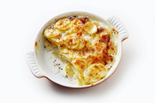 istock Delicious baked dish with potato and cream in ceramic pan on table 1403465115