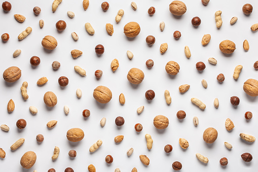Pattern made of various nuts: pistachios, walnuts, hazelnuts, macadamia, almonds and peanuts